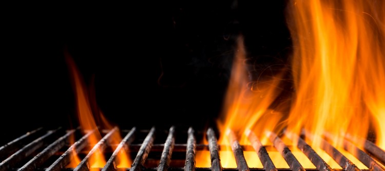 Empty grill grid with fire flames, isolated on black background